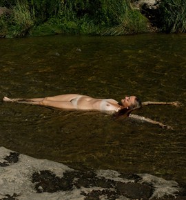 Sybil Kuechler relaxing nude in the river